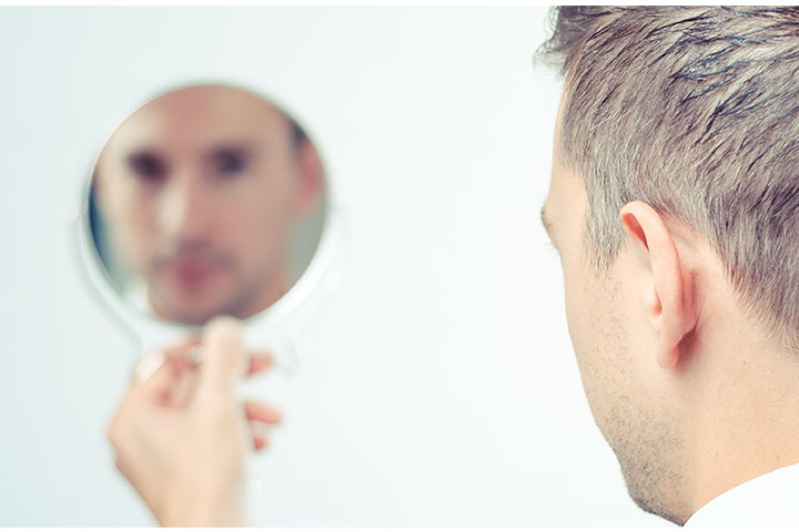 鏡を見る男性